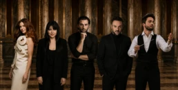 Group portrait of the conductor and four featured artists for the concert New Year's on Broadway, posed in an elegant classical interior.
